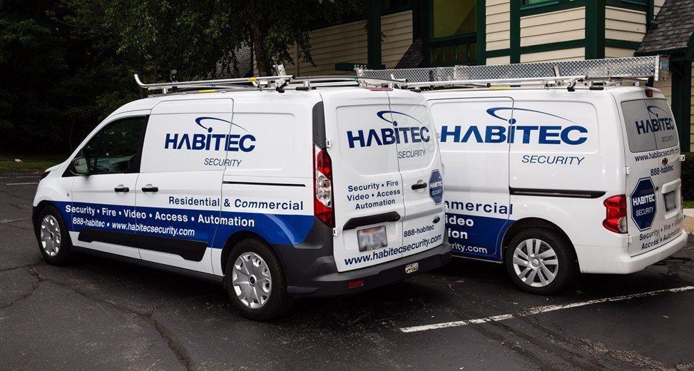 Two Habitec Security vehicles parked next to the office of the company in Delaware, Ohio
