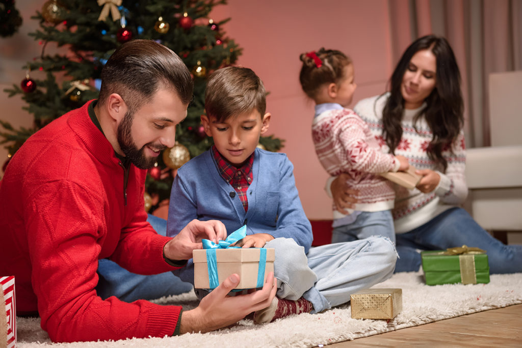 A family opening gifts during the holiday season