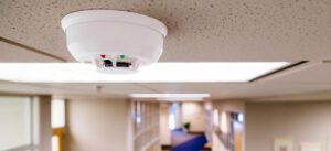 A Habitec Security smoke detector on the ceiling