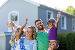 A happy family in front of their house