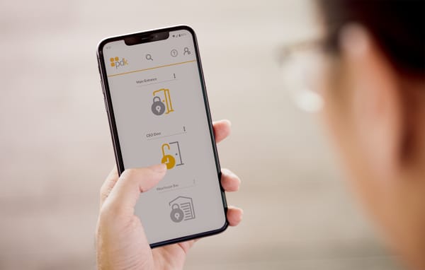 A person using PDK's access control app on their phone