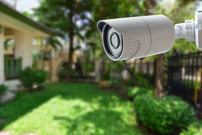 A CCTV security camera mounted outdoors monitoring a property